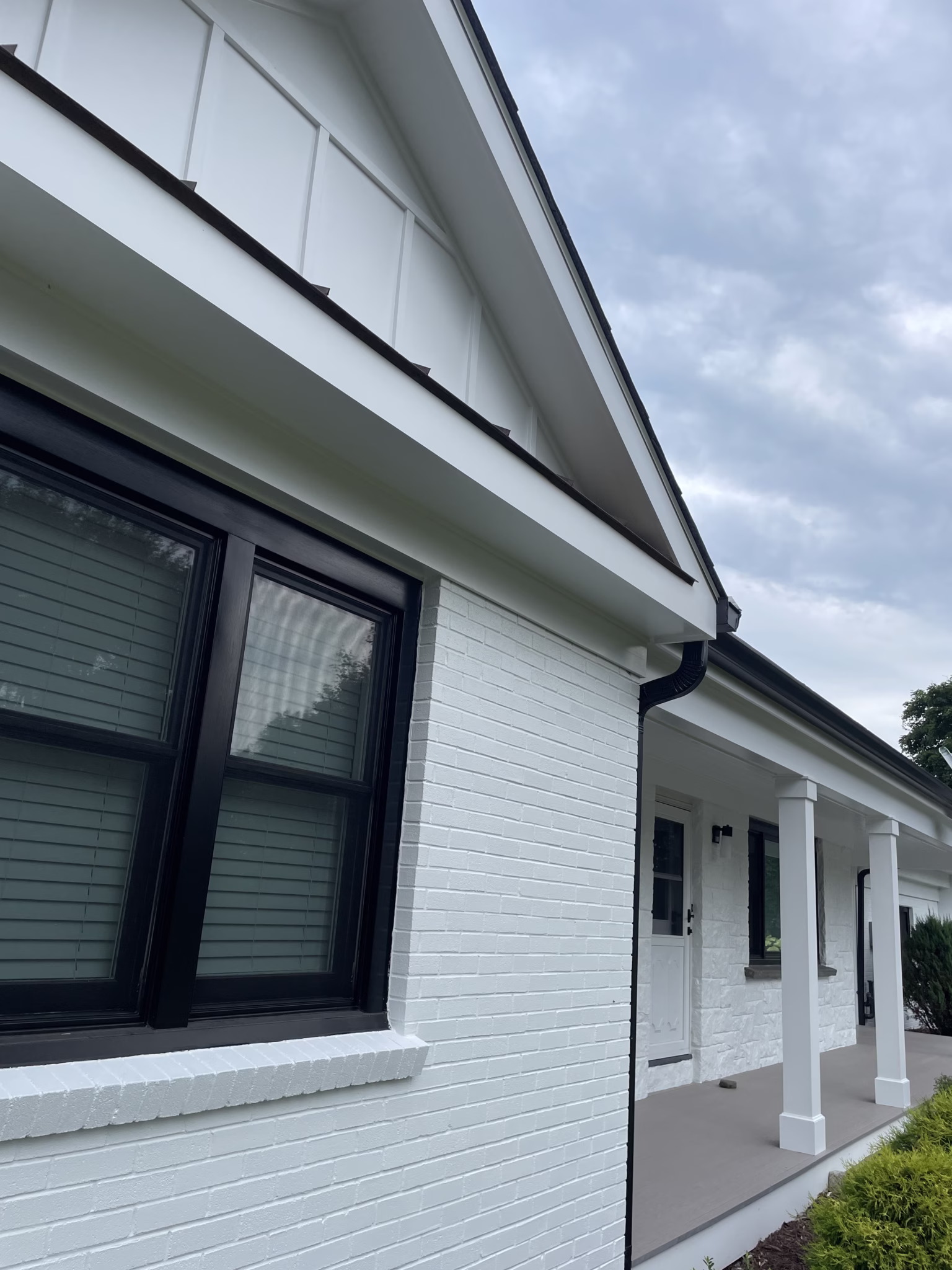 White painted brick exterior with dark trim