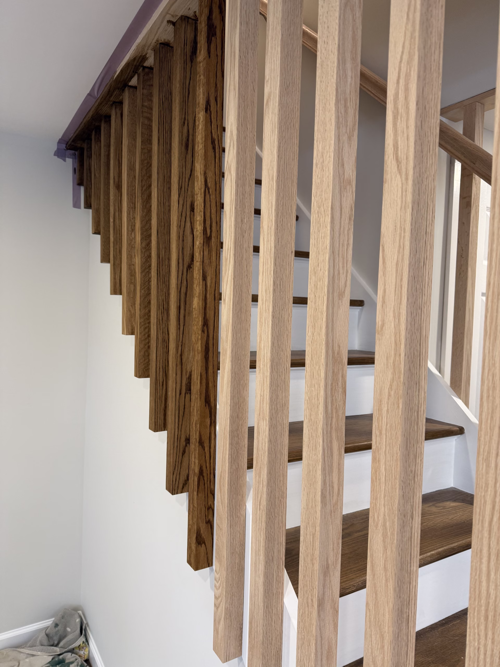 Stained wood stair spindles and painted basement trim in Easton CT