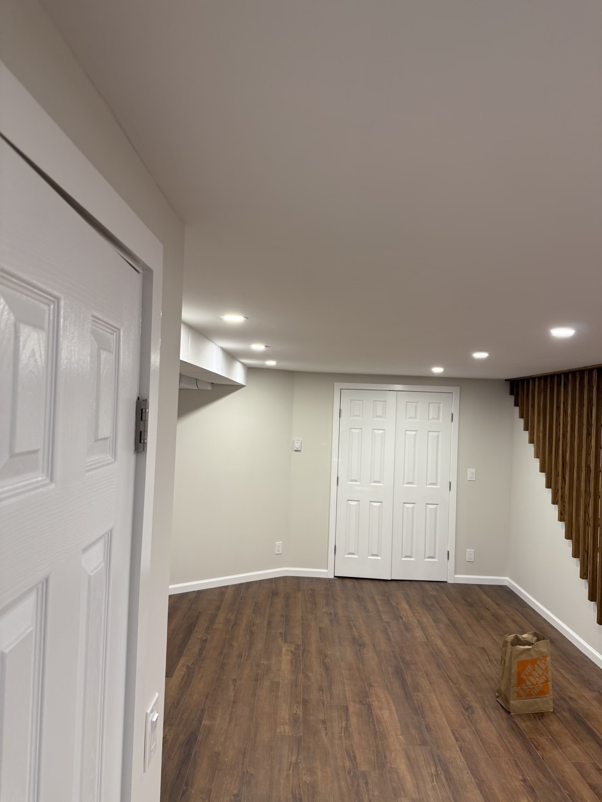 Stained wood stair spindles with painted white trim in Easton CT