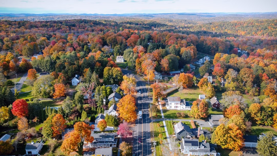 New England home in fall with exterior and gutters prepared for seasonal maintenance