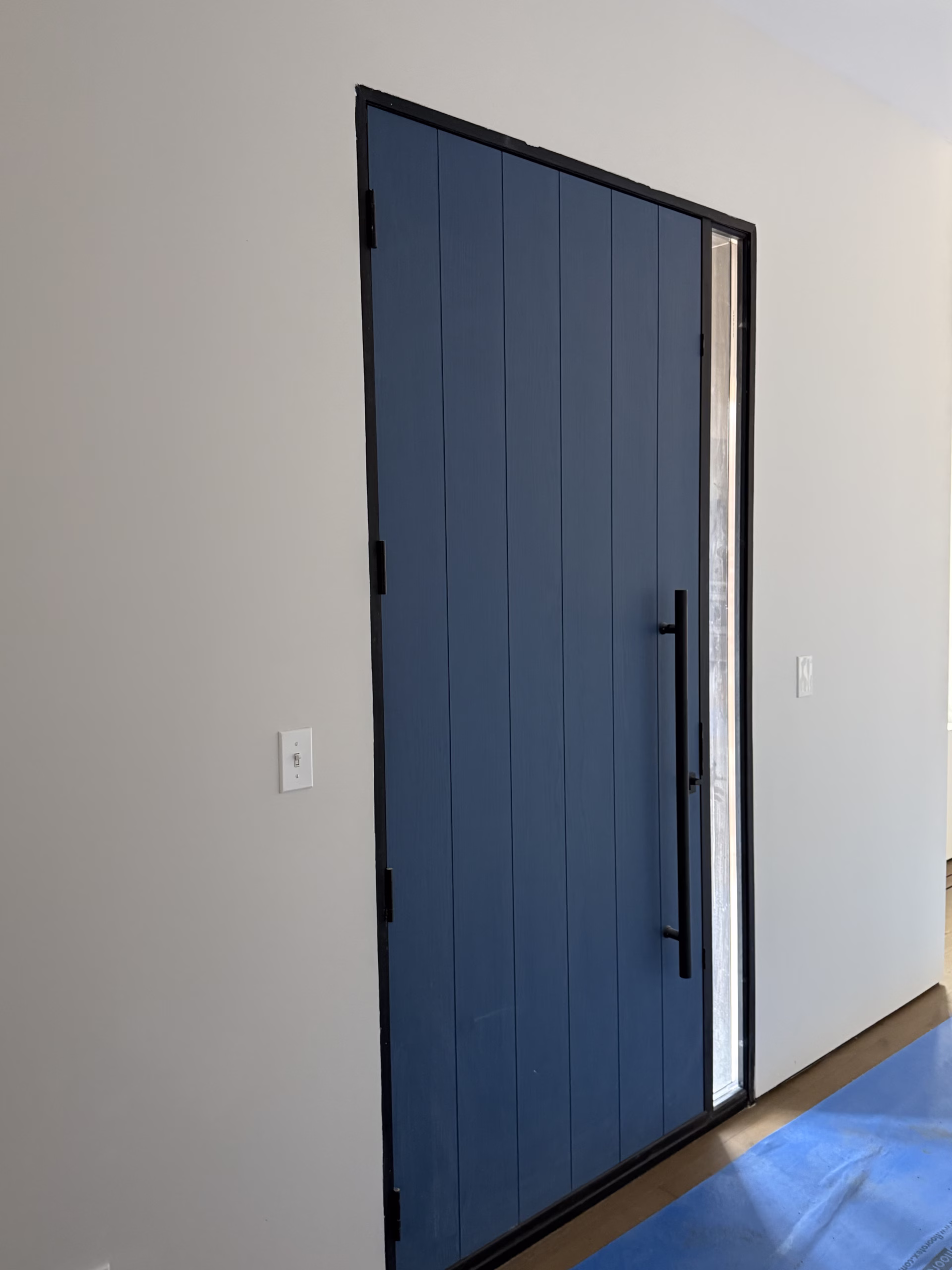 Painted interior entry door and trim during Newtown CT interior painting project