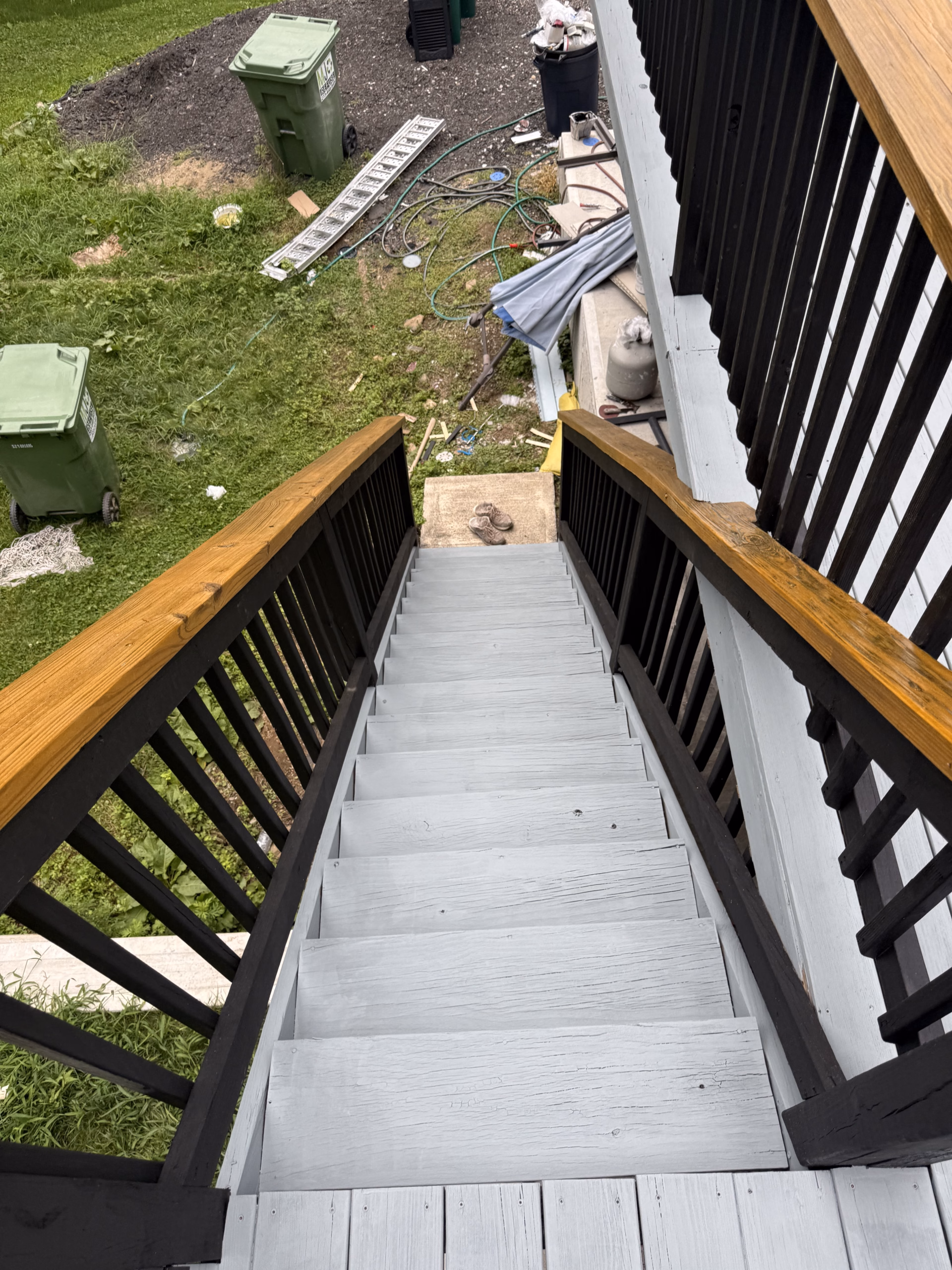 Restored deck stairs in Bethel CT with gray floor and contrasting black railings