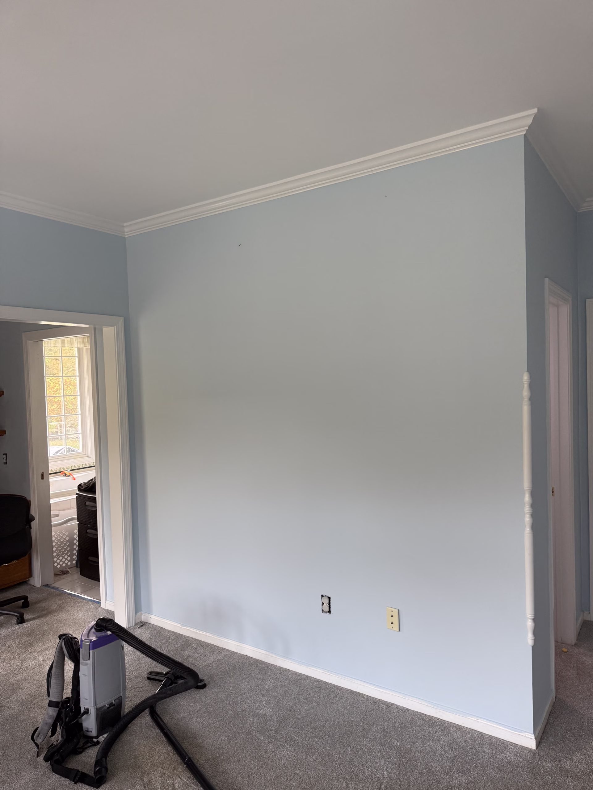 Finished bedroom interior painting in Bethlehem CT with light blue walls and white ceiling