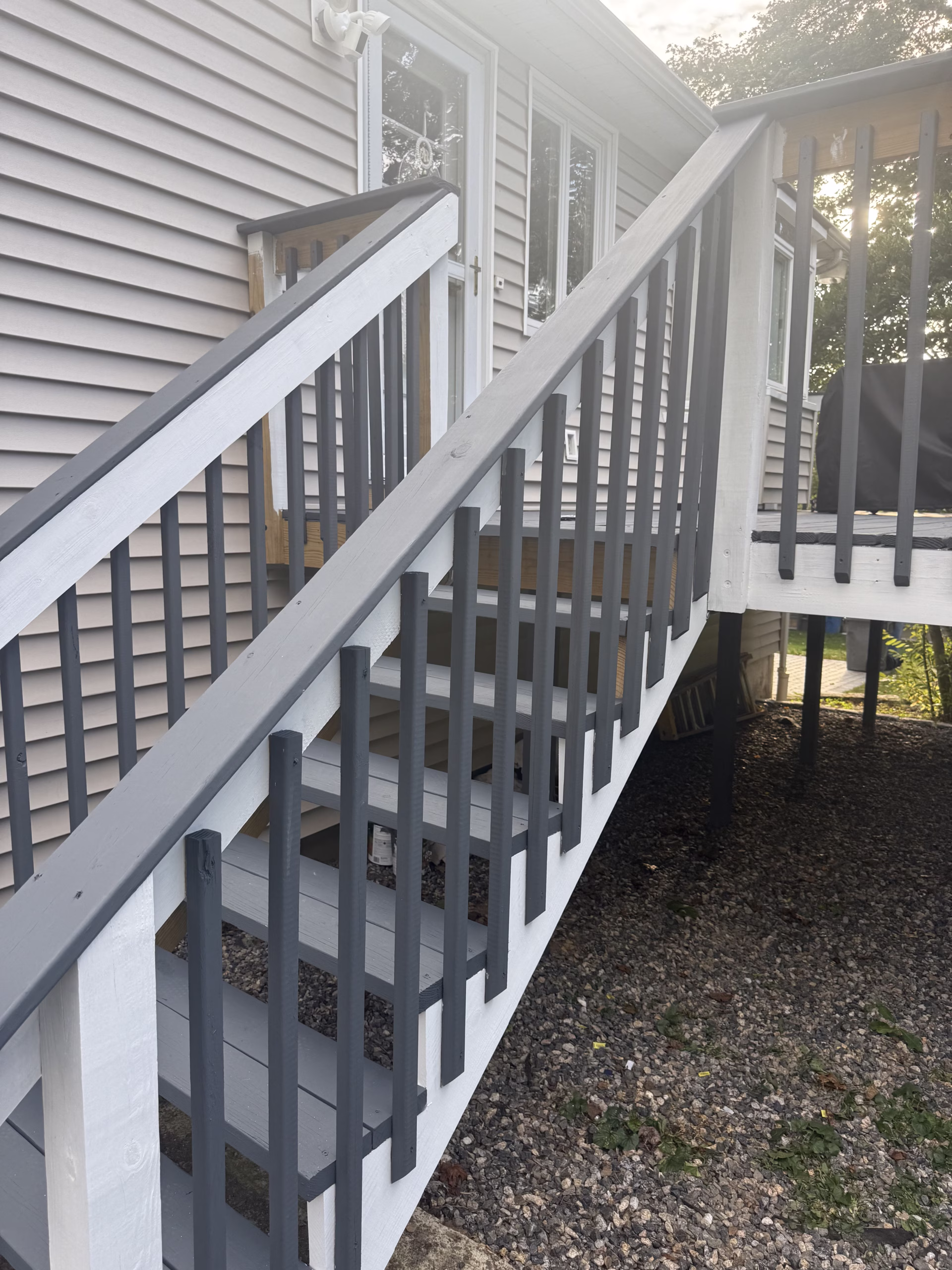 Painted deck stairs and railings in Monroe CT with dark gray and white finish
