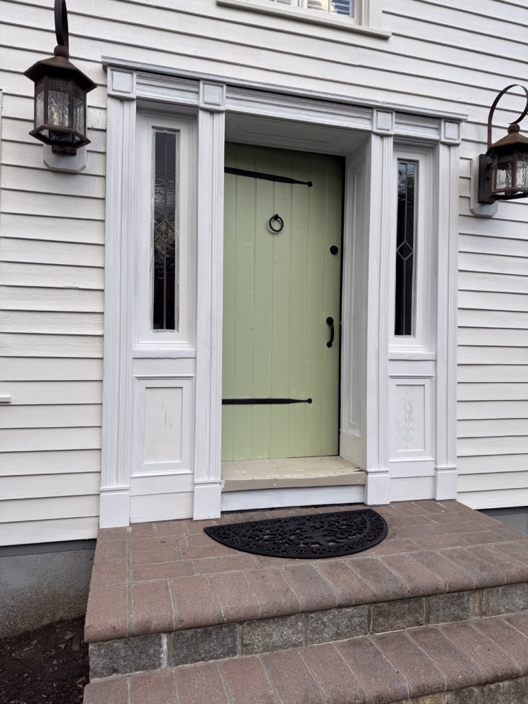 Off-white siding and detailed front-entry trim on Fairfield Pro Painting's Roxbury Connecticut project