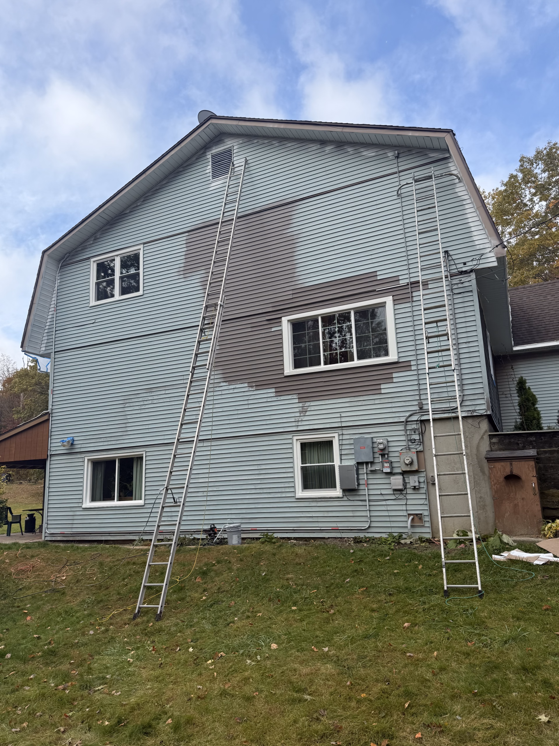 Older vinyl siding during preparation and spray painting in Middlebury CT