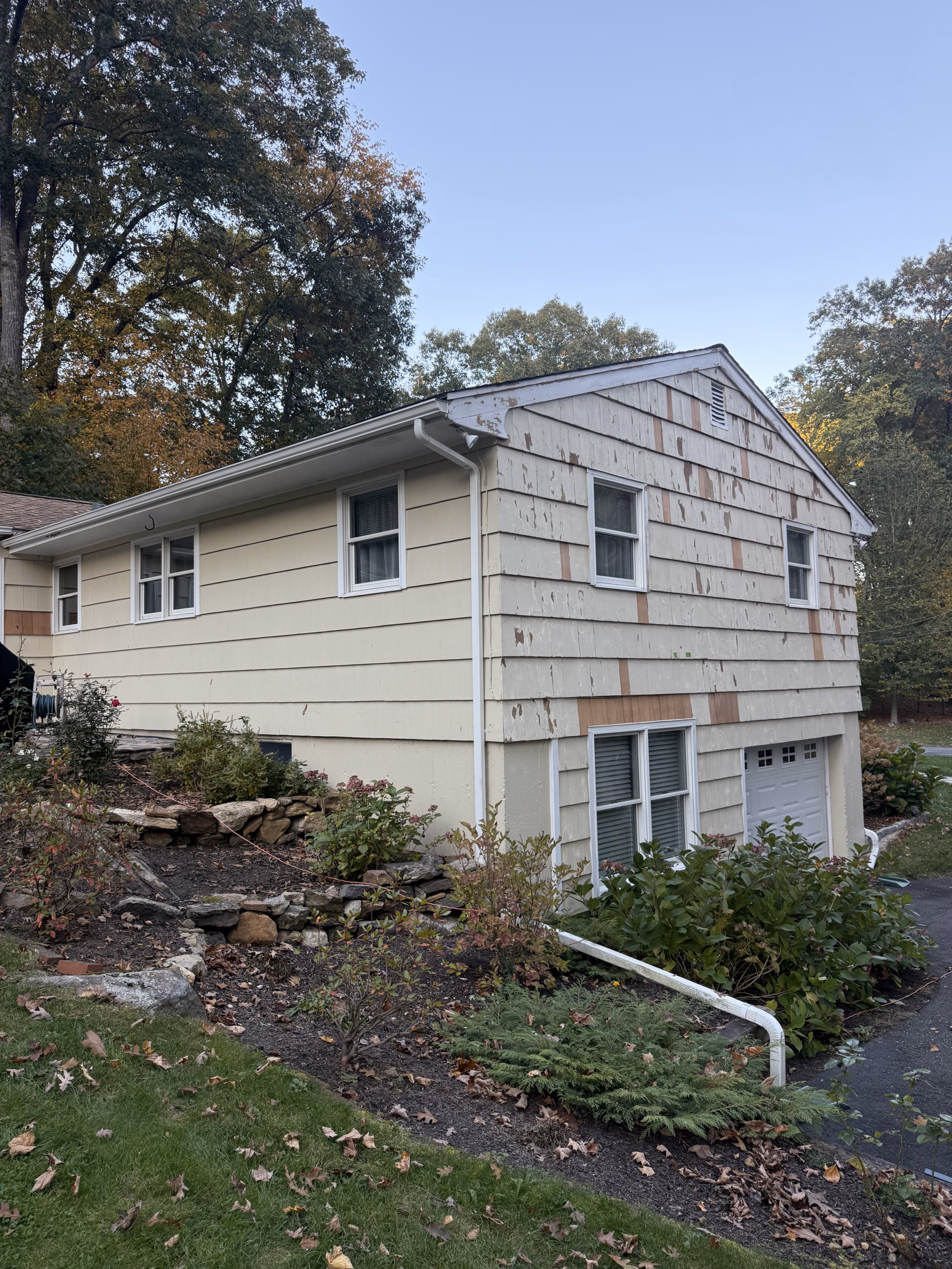 Original siding condition before exterior renovation and Woodland Green painting in Ridgefield CT.