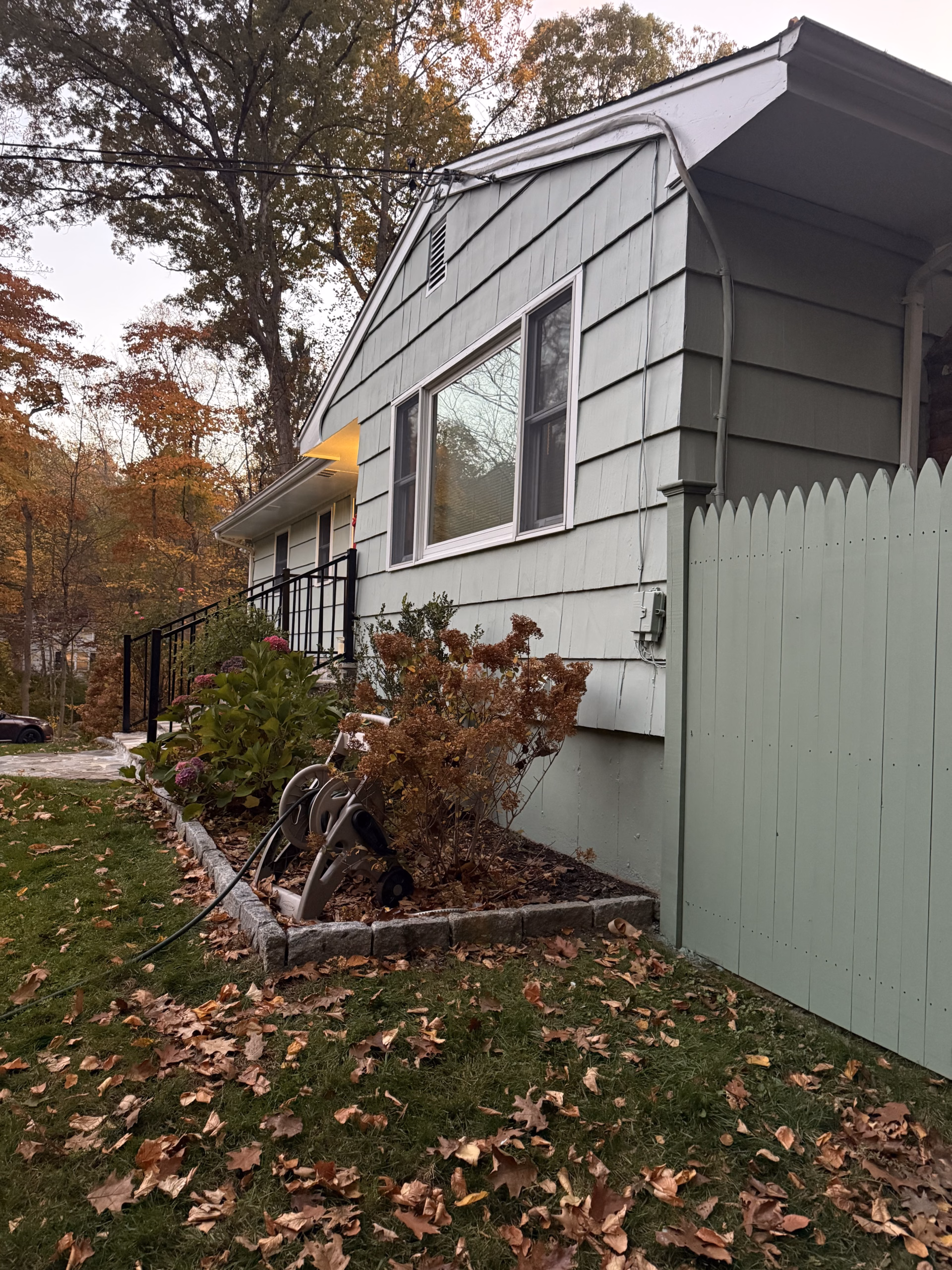 Completed green exterior and painted fence at a Ridgefield CT home.